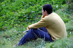 man sitting in grass