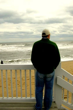 man looking at ocean